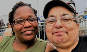 Yolanda Burnett and Mary Robinson smile for a picture while enjoying a baseball game